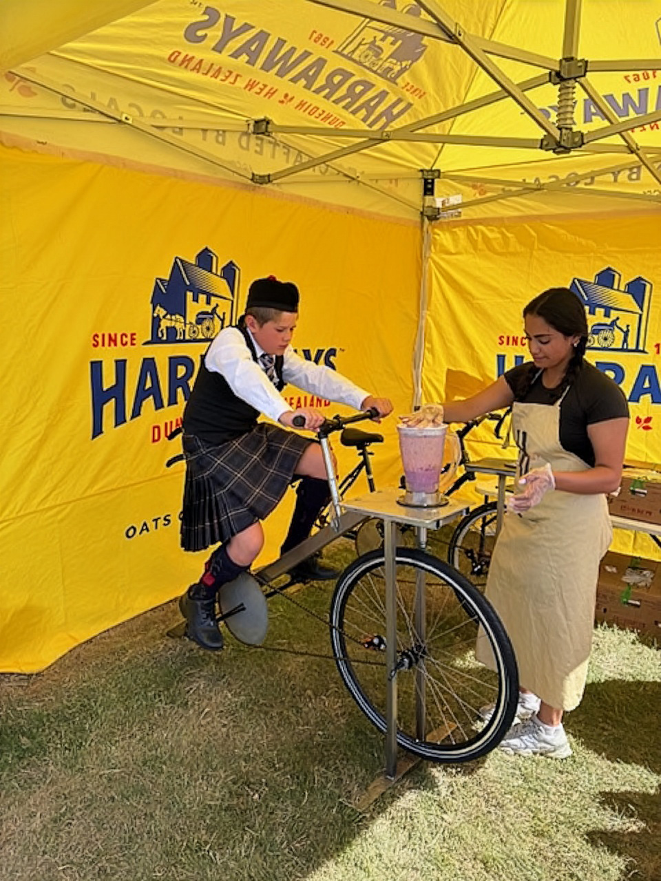 boy in kilt on smoothie making bike
